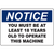Notice sign requiring operators to be at least 18 years old for safe machine usage in industrial settings.