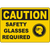 Yellow caution sign indicating safety glasses required for workplace safety and protection compliance.