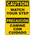 Yellow bilingual caution sign: 'Watch Your Step / Camine Con Cuidado' for safety in industrial environments.