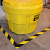 Yellow spill kit with hazard marking floor tape for safety and organization in industrial environments.