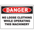 Warning sign: Danger - No loose clothing while operating this machinery for workplace safety.