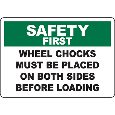 Safety first sign instructing to place wheel chocks on both sides before loading for industrial safety compliance.