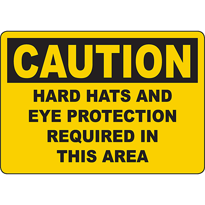 Caution sign indicating hard hats and eye protection required for safety in industrial areas.