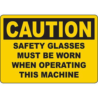 Caution sign: Safety glasses must be worn when operating machines for workplace safety compliance.