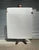 Tall artist holding a sheet of giant 400gsm watercolour drawing paper to demonstrate scale