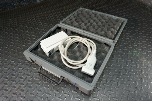 Siemens Acuson 6L3 ultrasound transducer probe in an open gray hard case with foam, alongside white accessories.