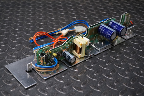 Apple LaserWriter power supply PCB showing clean components, bright metal chassis, and intact wiring harnesses.