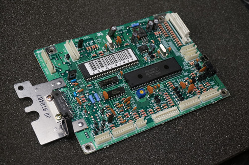 DC Controller board showing clean components and intact white connectors. Barcode text CACA295999. Metal bracket stamped J0 918407.