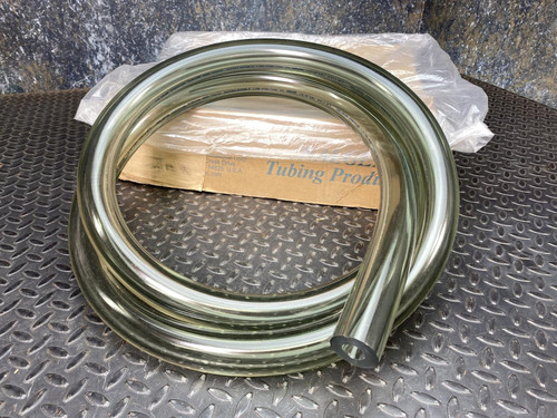 Nalgene 8000-1325 clear PVC vacuum tubing coiled on a diamond plate surface with original packaging.