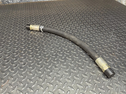 Caterpillar 3N6504 hydraulic replacement hose with metal fittings on both ends, lying on a diamond plate surface.