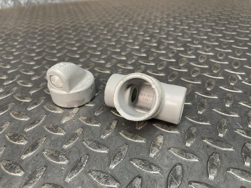 Killark EYS-1 1/2 inch conduit fitting shown disassembled on a diamond plate surface.