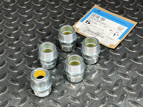 Five Cooper Crouse-Hinds CG100 750 strain relief connectors and product label on a diamond plate surface.