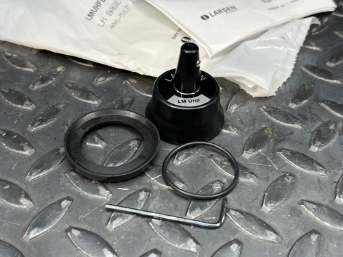 Randell Larson LM-400 Series UHF replacement coil, gasket, O-ring, and hex key on a metal surface.