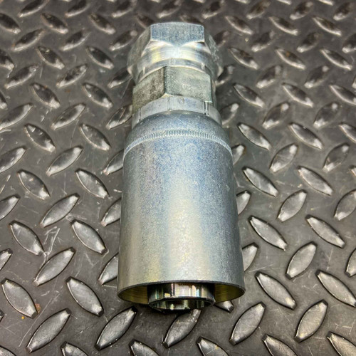 Eaton 47020E-620 1-1/4 inch hydraulic hose fitting standing on a diamond plate surface.