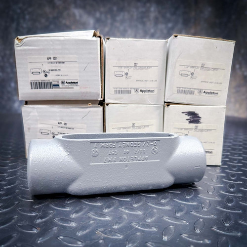 Six unused Appleton 1-1/2-inch Grayloy Type C conduit bodies, with one gray body in front of six boxes.