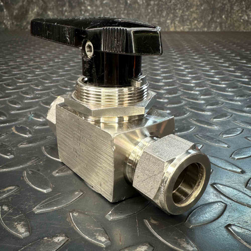 Swagelok SS-45S12 3/4 inch ball valve with black handle and tube fitting connections on a metal surface.