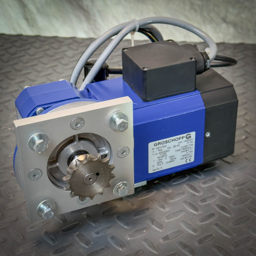 Angled front view of a Groschopp WK 1695401 Angled Gearmotor VE 31-G-R-5 i:75 3PH from Obtainium Science and Surplus, showing the output shaft with mounted sprocket and identification label.