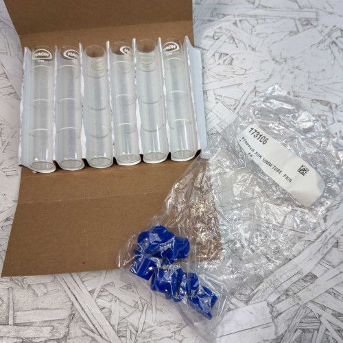 6-Pack, Hach 173006 Viewing Tube 5 mL / 10 mL Marks with Stopper from Obtainium Science and Surplus shown with six clear glass tubes in a cardboard holder and a bag of blue stoppers labeled 173106.