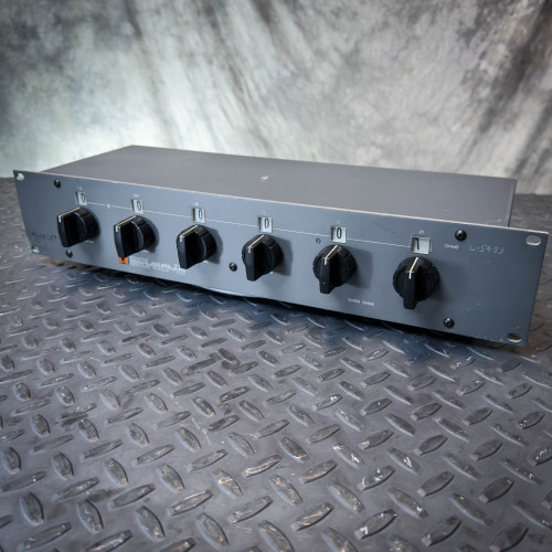 Dekastat SP1298 Precision Decade Resistor Rack from Obtainium Science and Surplus, shown angled on a textured metal surface with multiple black control knobs on its front panel.