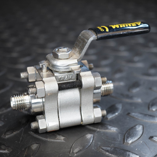 Whitey SS-62TS4 stainless steel ball valve with black handle and 1/4 inch threaded connections.