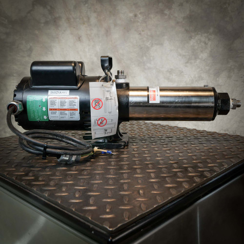 Dayton booster pump showing intact stainless steel housing and motor casing. Original warning tags attached.