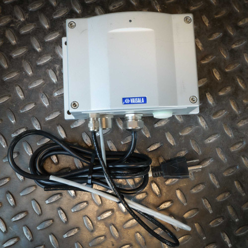 Vaisala transmitter enclosure showing light surface wear. Sensor wires cut flush at the cable glands. Power cord included.