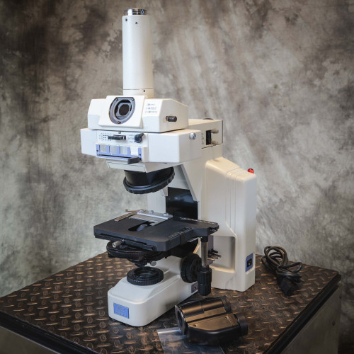 Nikon Eclipse E600 microscope frame showing general surface grime, missing binocular head, power cord included.