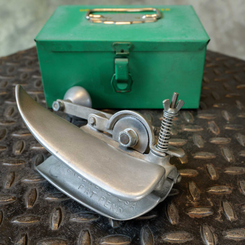 Greenlee flex cutter showing light use wear. Stamped text: "GREENLEE U.S.A." and "PAT. PEND." Cutter wheel intact. Green case shows paint overspray.