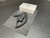 MSA lapel mic with coiled cord on a gray mat, white MSA box behind it