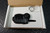 Close view into the open box with the lapel mic and bagged ring