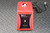 Red housing with minor surface scuffs. Front panel shows speed dial and mode switch. Cup head absent; knob and mixing plate absent.