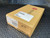 Cardboard box with Polycom branding, "Rev: C" and PN 2215-26928-031ACK visible. Handwritten "#12" on side.