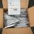 Top-down view of an open box showing many sealed packets of 3M 6600-S LC Simplex Hot Melt Fiber Optic Connectors from Obtainium Science and Surplus.