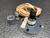 Kistler-Morse transducer on its flange beside a coiled cable, coupling and pipe nipple