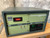 Red LED display reads 1800°C; green digital panel reads 9999. Light scuffs on olive-green sheet metal. Powers on confirmed.