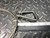 48" stainless steel cable with carabiner from Obtainium Scientific Surplus with a carabiner, measured against a ruler on a diamond-patterned metal surface.