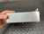 Brushed aluminum housing showing light surface scratches, no dents. Grounding lugs visible on right end.