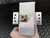 PolyPhaser surge protector showing brushed aluminum finish, N-type female connector with minor discoloration, and two intact mounting brackets.
