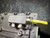 Close-up of the connection panel on the SICK LiDAR Scanner, featuring a yellow cable and mounting components. This is part of the 360° 2D long-range LiDAR sensor from Obtainium Science and Surplus.