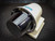 SICK LiDAR sensor angled to show its round black window and bolted ring