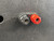 Red and black binding posts showing minor scuffs and dust, banana plug holes clear, screw terminals appear intact.