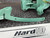 Close-up view of the CS Unitec Pneumatic Chainsaw's handle and attachment parts, highlighting the label 'HardTOP CE Performance Forestry Equipment'.
