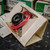 Angled view of the opened box with the black coil and red leads visible