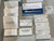 Boxed spare parts labeled N077-0437 and N077-0438 with handwritten notes