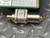 Brushed stainless cylindrical transmitter module with threaded male fitting; orange o-ring visible at rear port; minor surface scuffs on body.