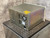 LDS control panel rear showing fan, power inlet, multiple ports. LDS label, CE mark. Metal casing with iridescent patina.