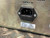 Power inlet with IEC C14 connector, screws intact, minor scuffs on metal casing. Label: "SUPPLY 100V/120V FUSE T 1A 250V 200V/240V T 500mA 250V".