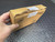 Hand holding the carton end with torn tape and a recycling symbol