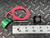 Gems Sensors LS-1700 level switch with red wires, green label, and black Delaval float on a metal surface with a ruler.