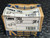 Neer 1904 1-1/4 inch EMT conduit straps in original, worn packaging displaying product details.
